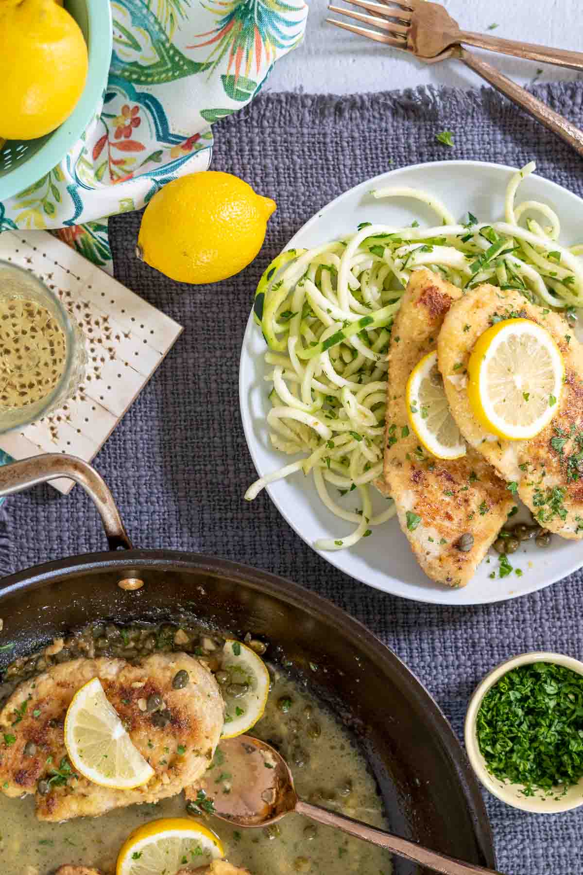 Chicken piccata being served from the saute pan.