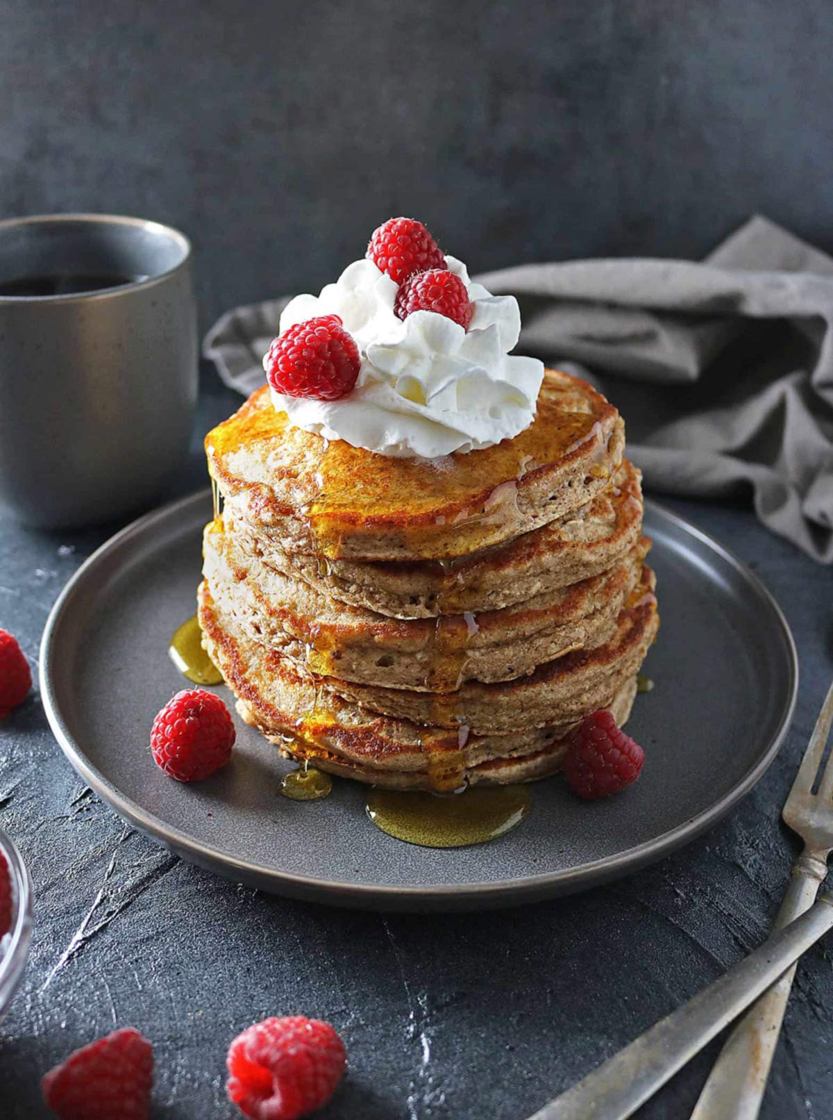 stack of oat flour pancakes with whipped cream