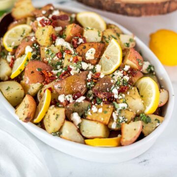 roasted potatoes with feta topping in serving bowl