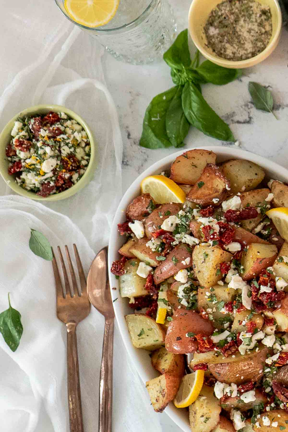 Roasted potatoes with a bowl of lemon and feta topping.