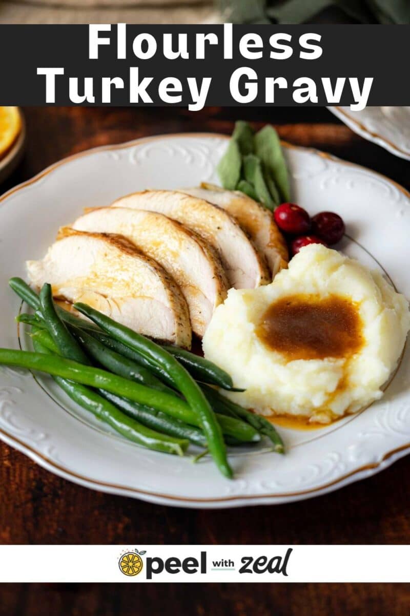 A plate with sliced turkey breast, green beans, mashed potatoes with gluten-free turkey gravy, cranberries, and sage leaves. Text reads: “Flourless Turkey Gravy. Peel with Zeal.”.