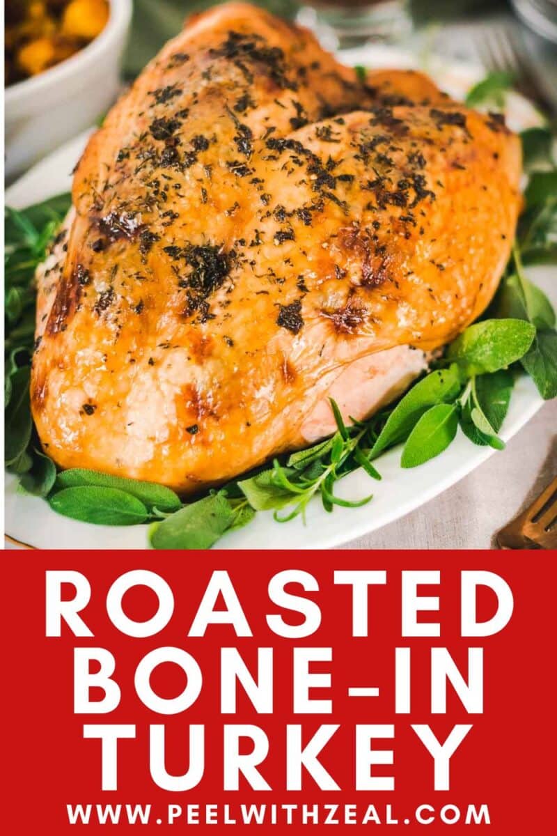 A roasted bone in turkey breast is served on a platter with fresh herbs