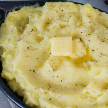 creamy mashed potatoes in bowl with butter