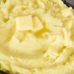 creamy mashed potatoes in brow serving dish