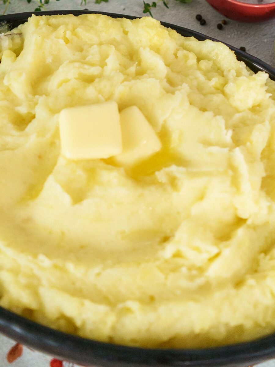creamy mashed potatoes in brow serving dish