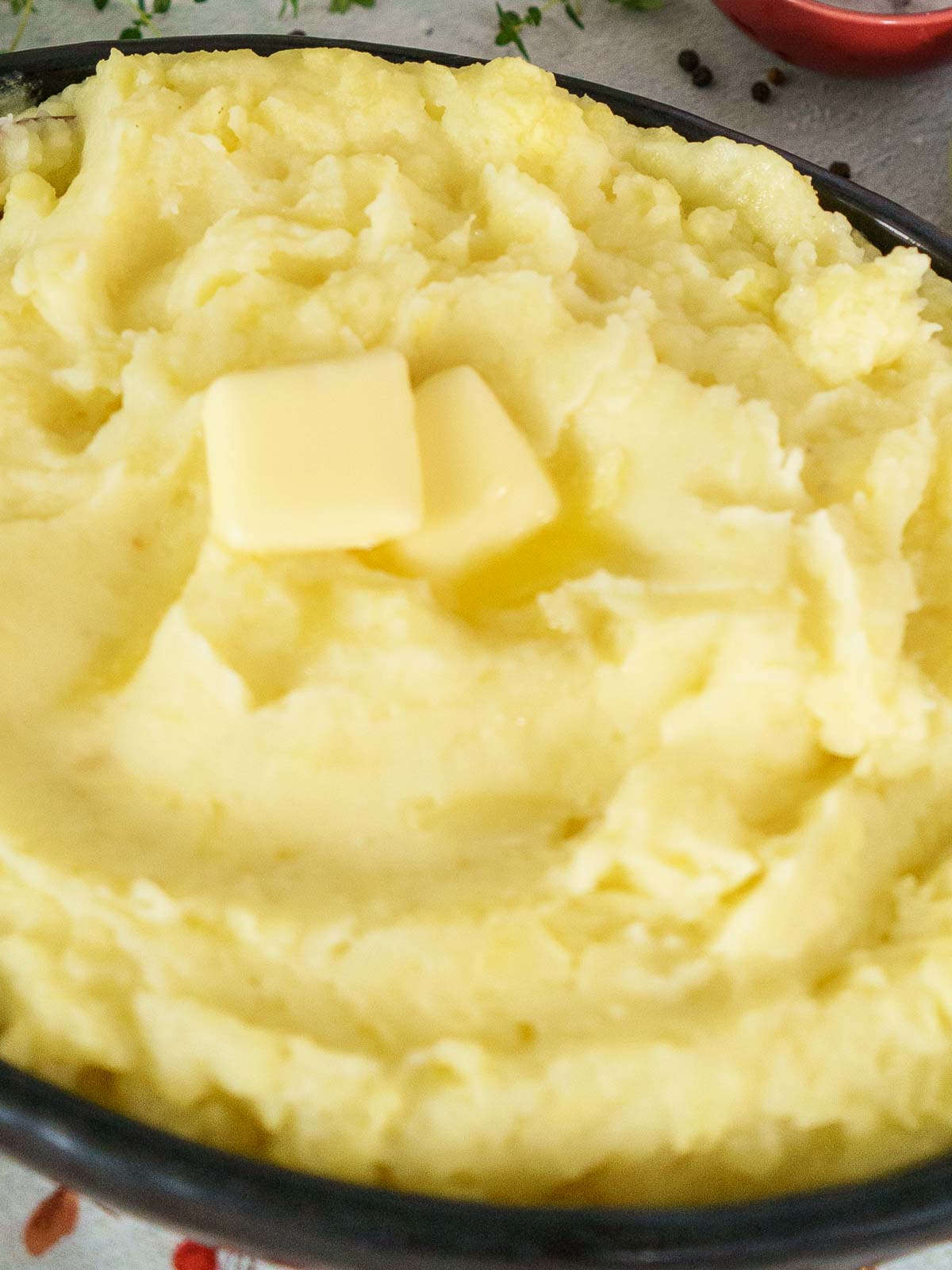 creamy mashed potatoes in brow serving dish