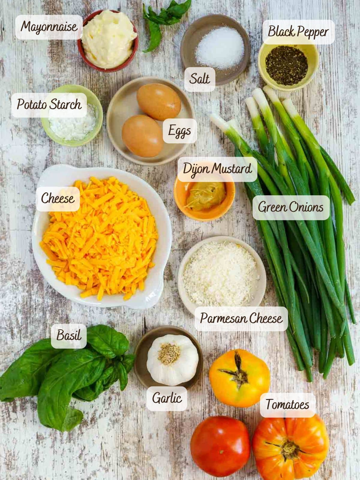 Various labeled ingredients are arranged on a rustic surface, including eggs, cheese, tomatoes, green onions, mayonnaise, spices, herbs, starch-and perfectly cooked sous vide pork tenderloin.