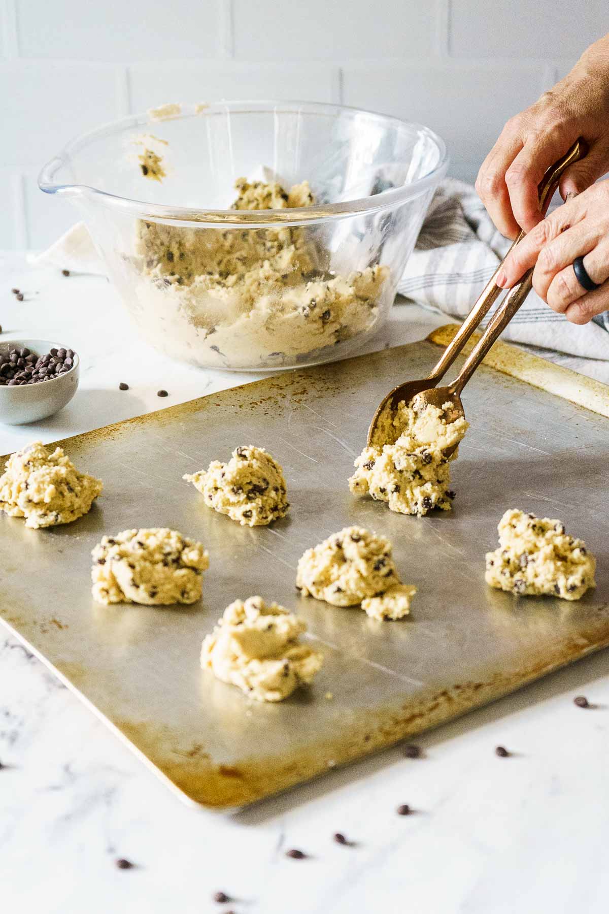scooping dough onto cookie sheet
