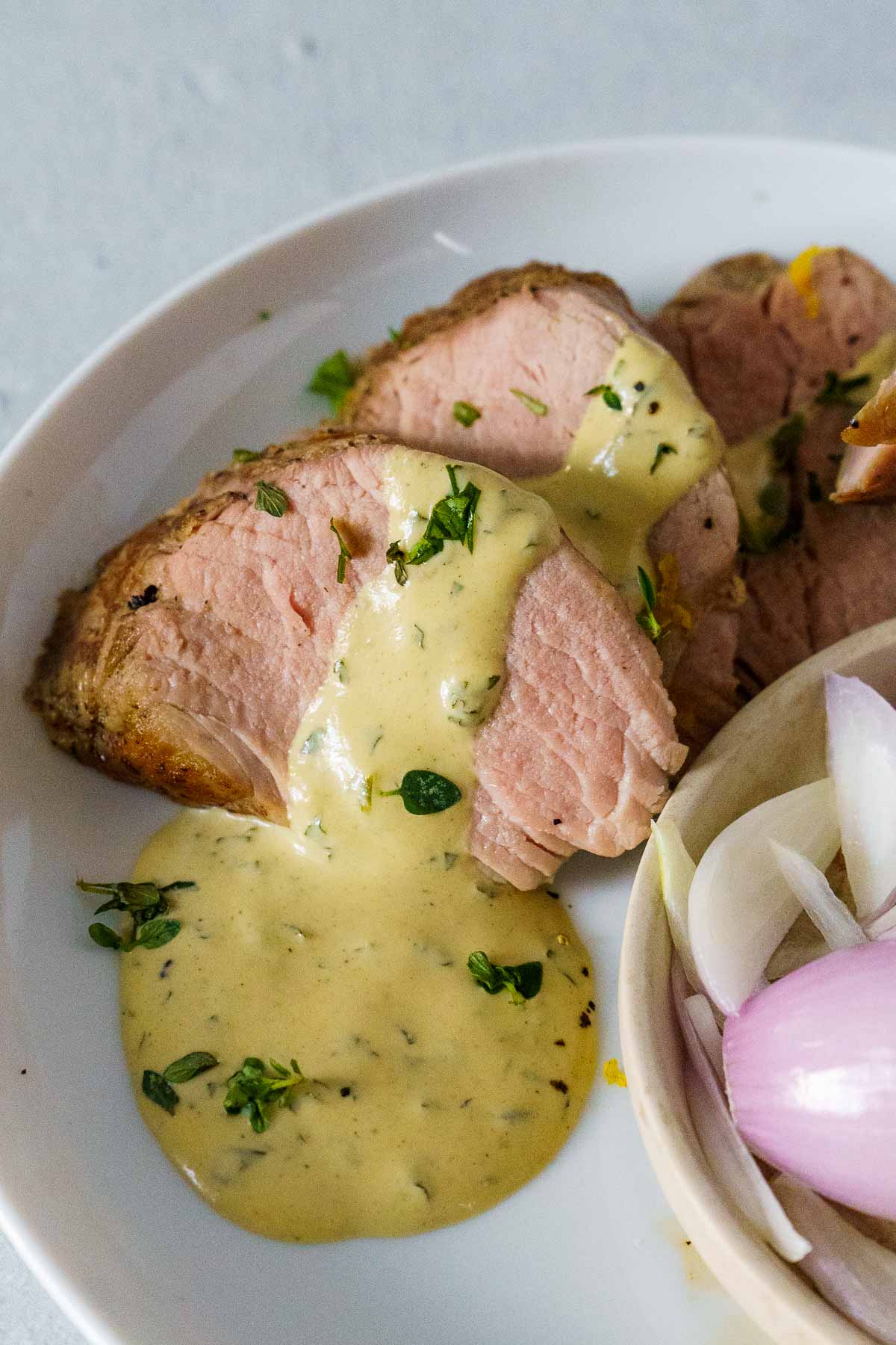 close up of sous vide pork tenderloin with mustard cream sauce