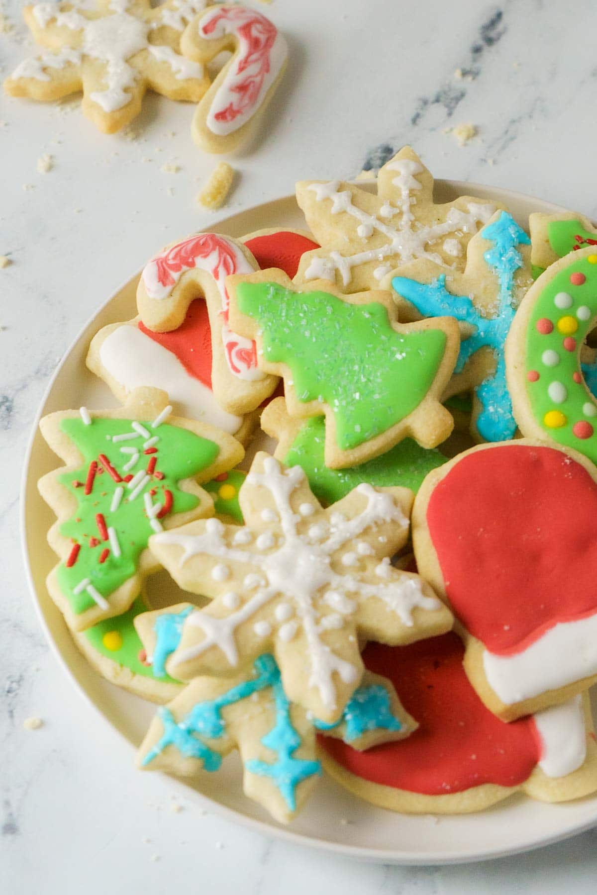 gluten free sugar cookies decorated for Christmas, on a plate