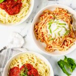 bowls of pasta with marinara sauce