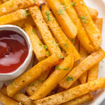 rutabaga fries on a plate with ketchup