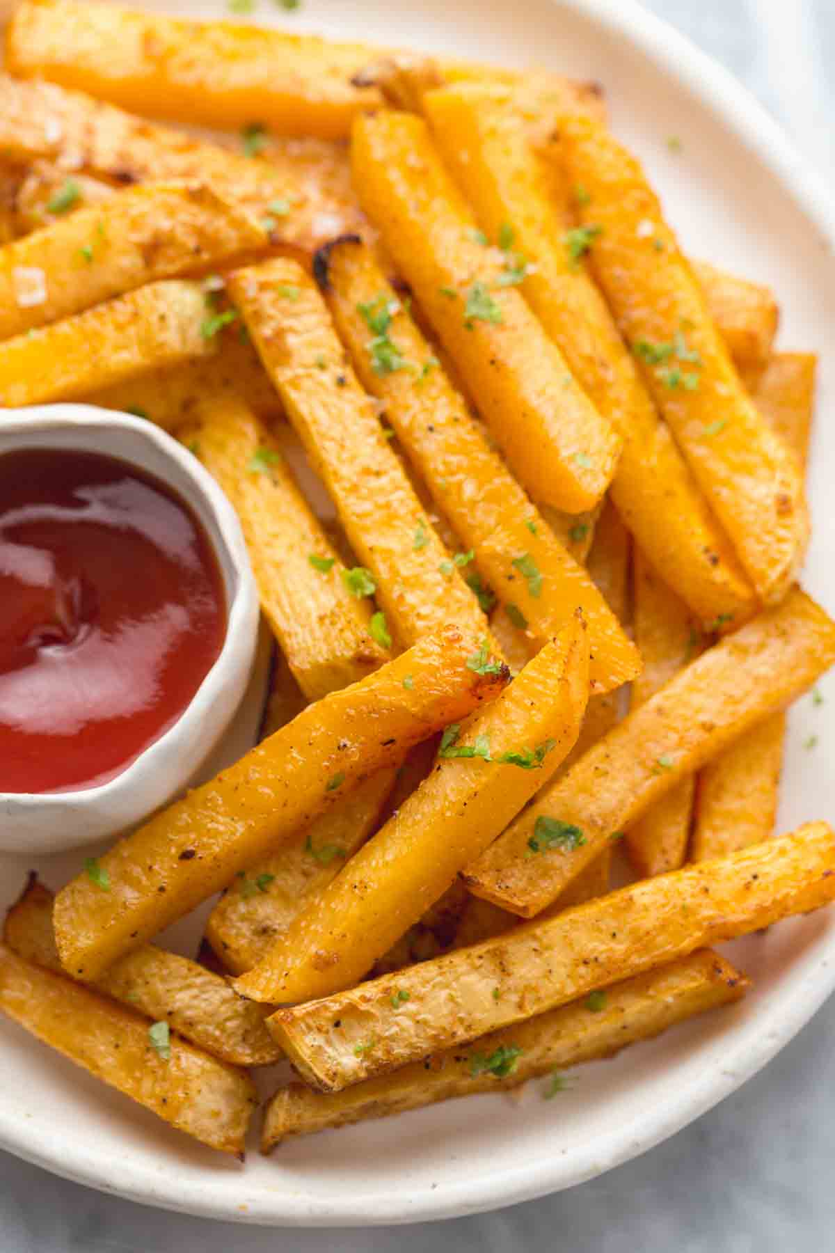 rutabaga fries on a plate with ketchup