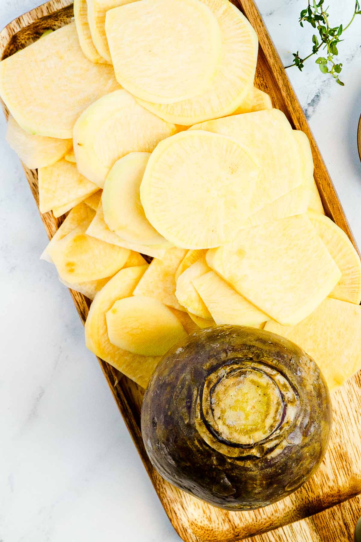 thinly sliced rutabaga on cutting board