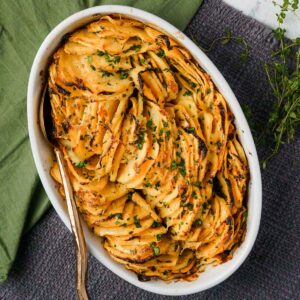 rutabaga slices in a baking dish with a spoon