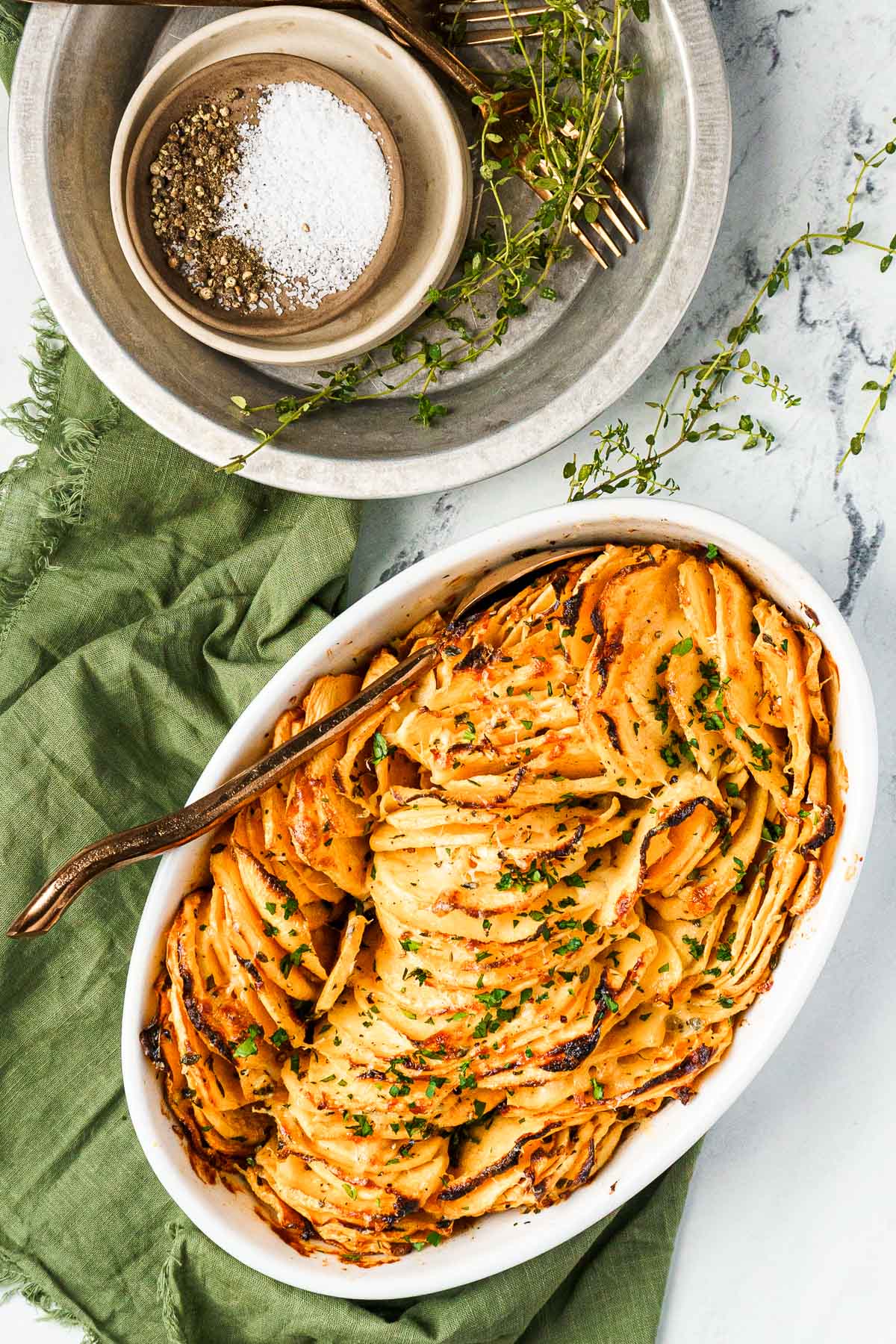 rutabaga slices in a baking dish with plates on the side