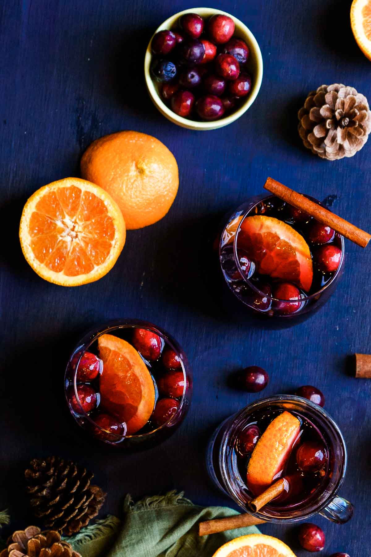glasses of spiced wine on a counter with orange slices