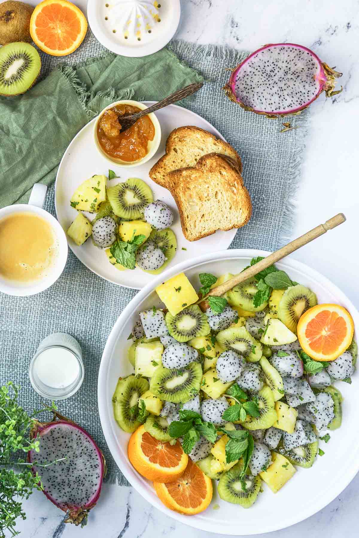 dragon fruit salad in serving bowl with a plate of toast