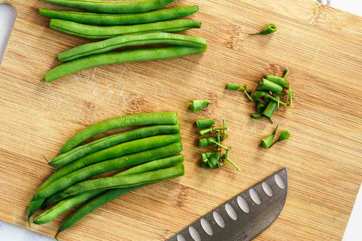 Trimming the ends of the green beans before cooking. 