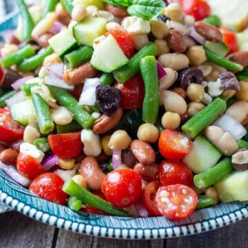 bean salad in serving dish on wood table