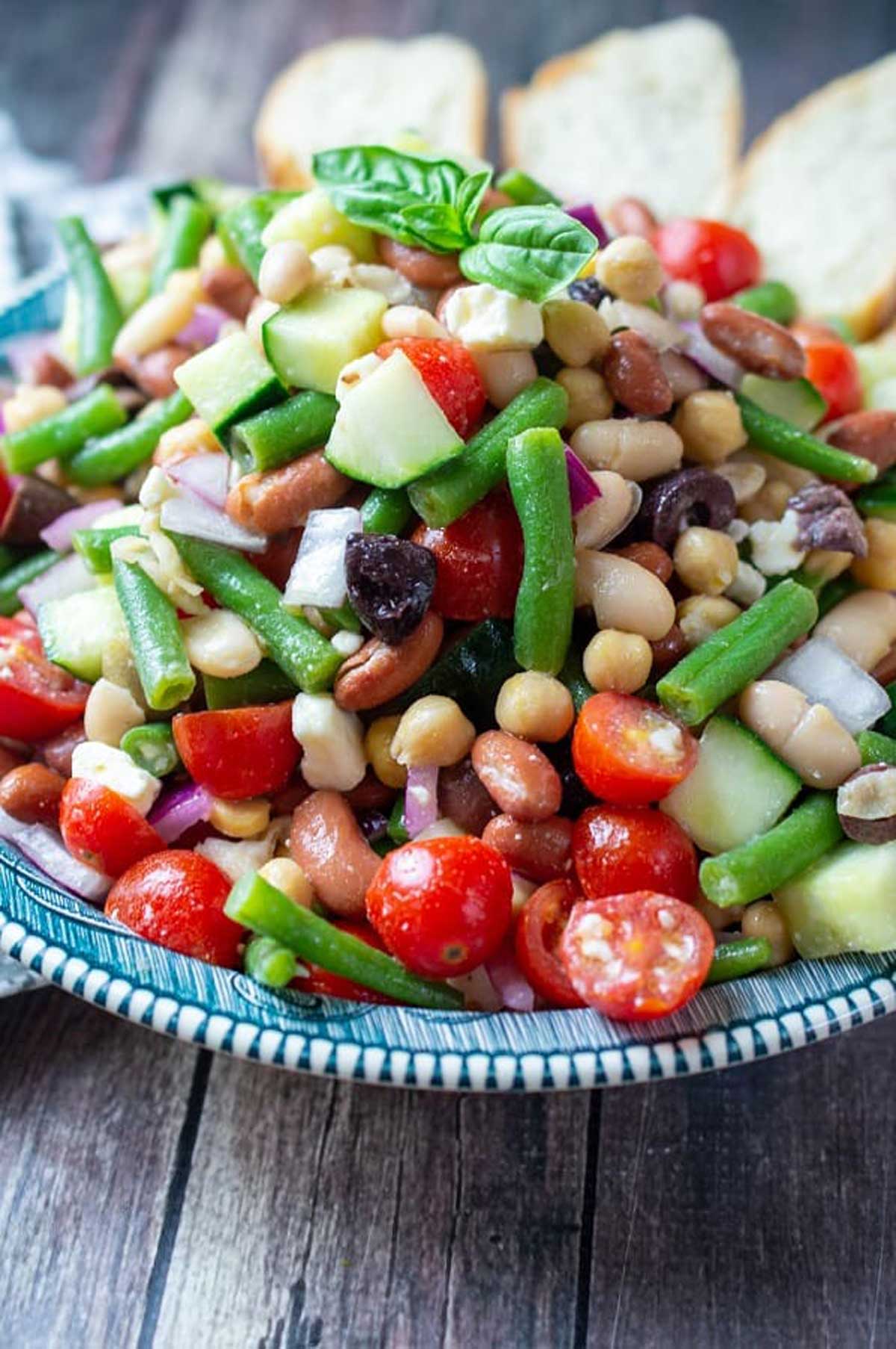 bean salad in serving dish on wood table