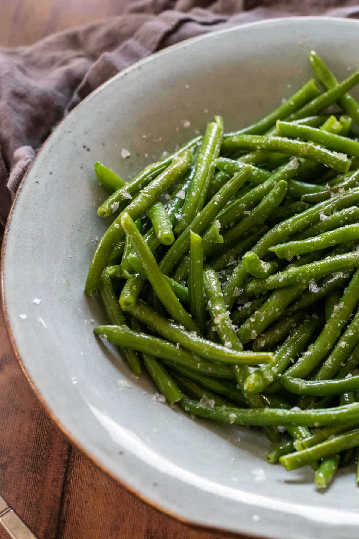 green beans in bowl with salt