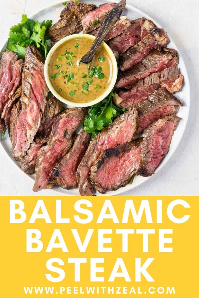 Sliced balsamic bavette steak arranged on a plate with fresh parsley and a bowl of sauce, showcasing the rich flavors of bavette steak from above.