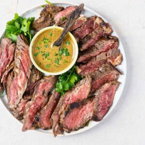 sliced bavette steaks with balsamic sauce in small bowl