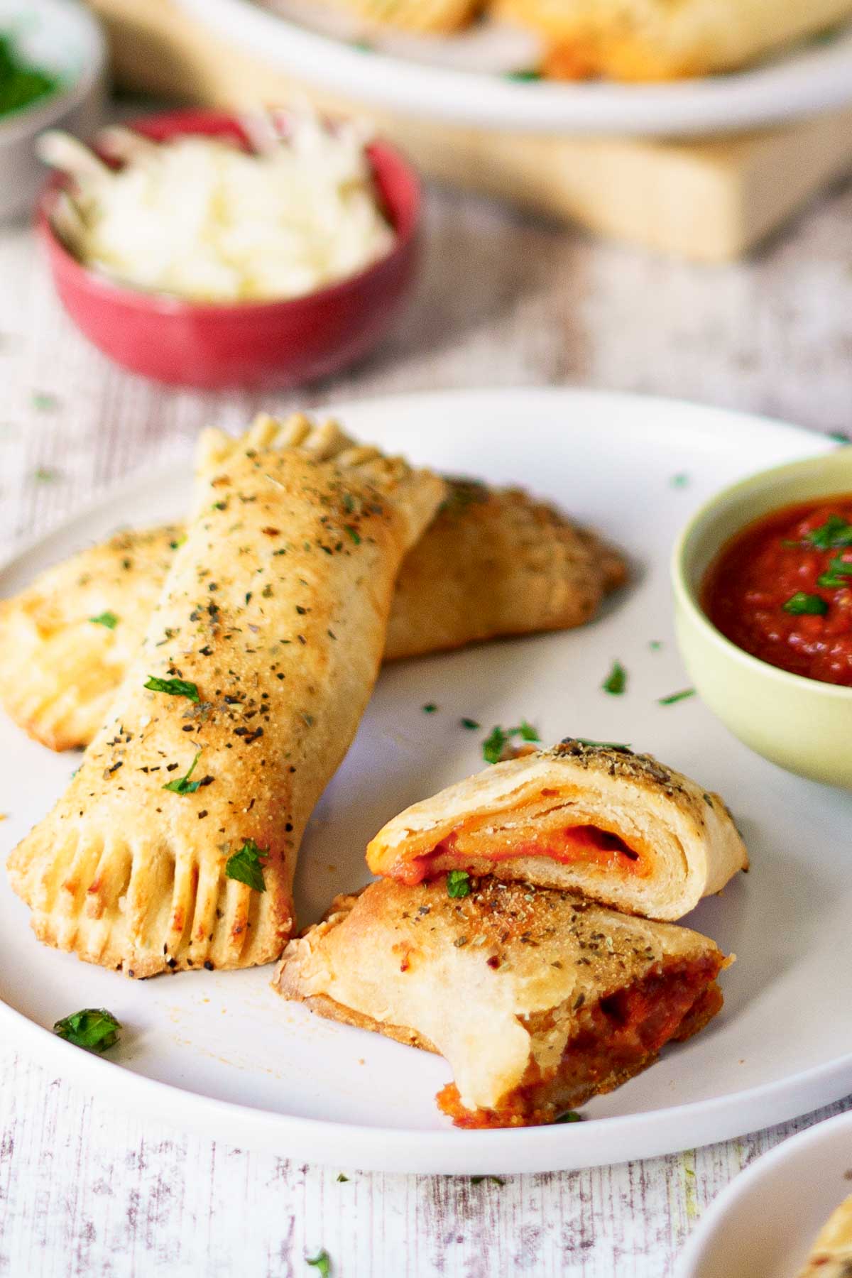 pizza roll cut in half on a plate