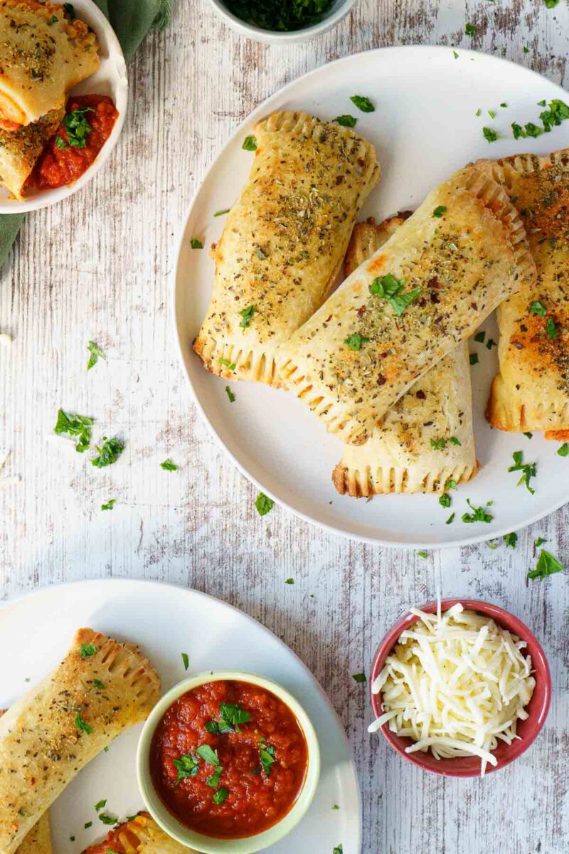 overhead shot of plates with pizza rolls and a side of sauce