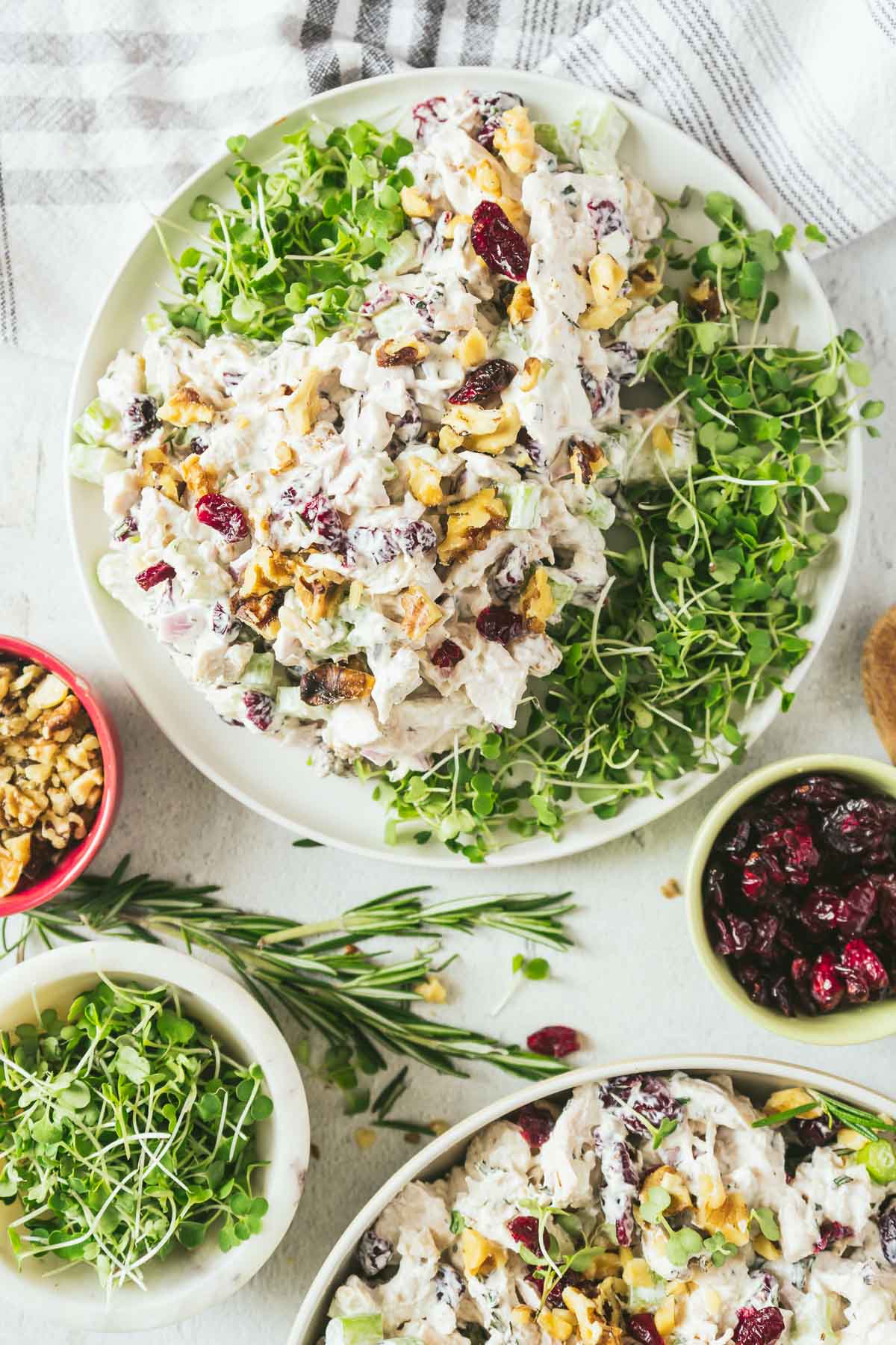two bowls of creanberry chicken salad served over lettuce. 