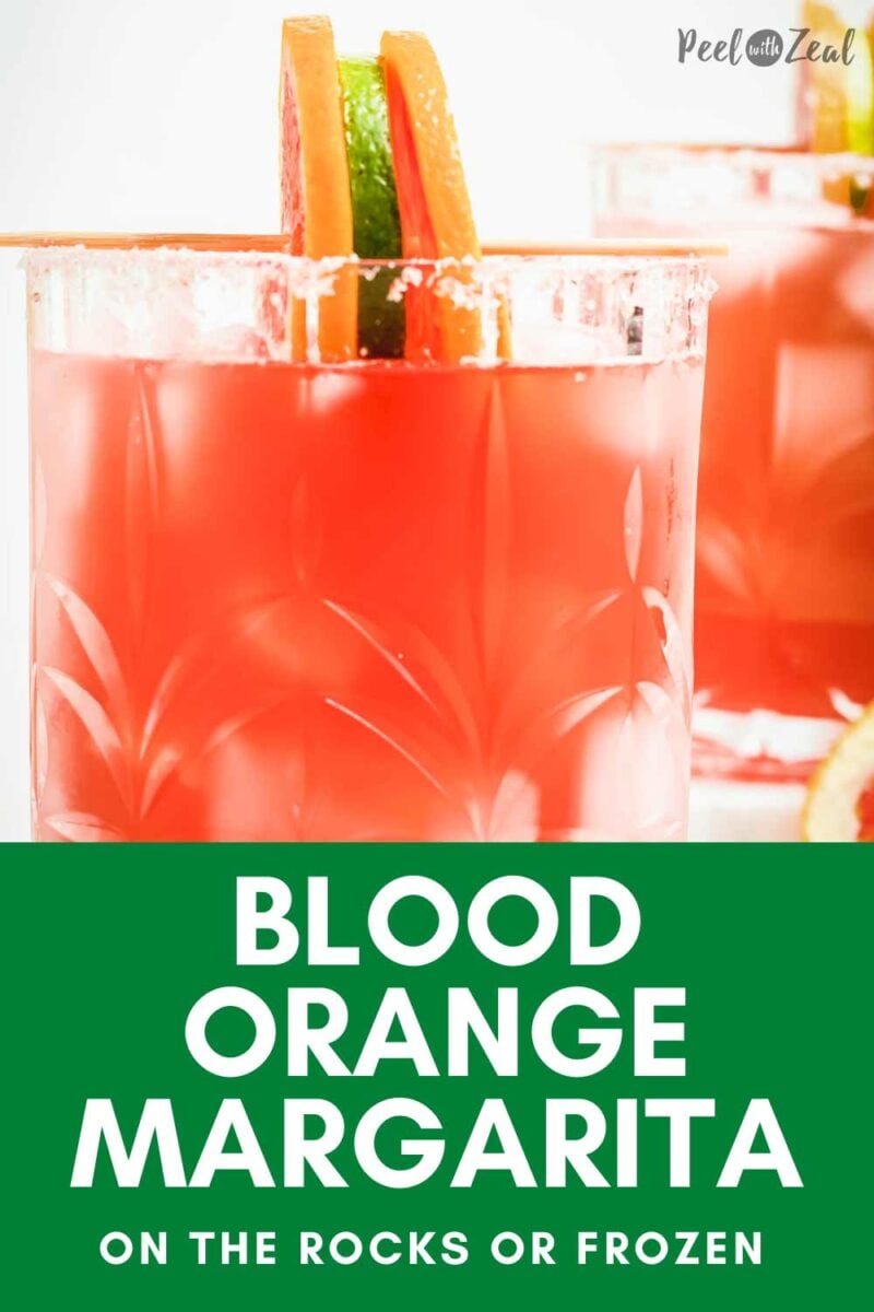 blood orange margaritas in a rocks glass with orange wheel.