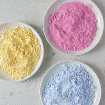 Colored Powdered Sugar on three plates.