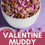 bowl of pink muddy buddy chex mix in a white bowl