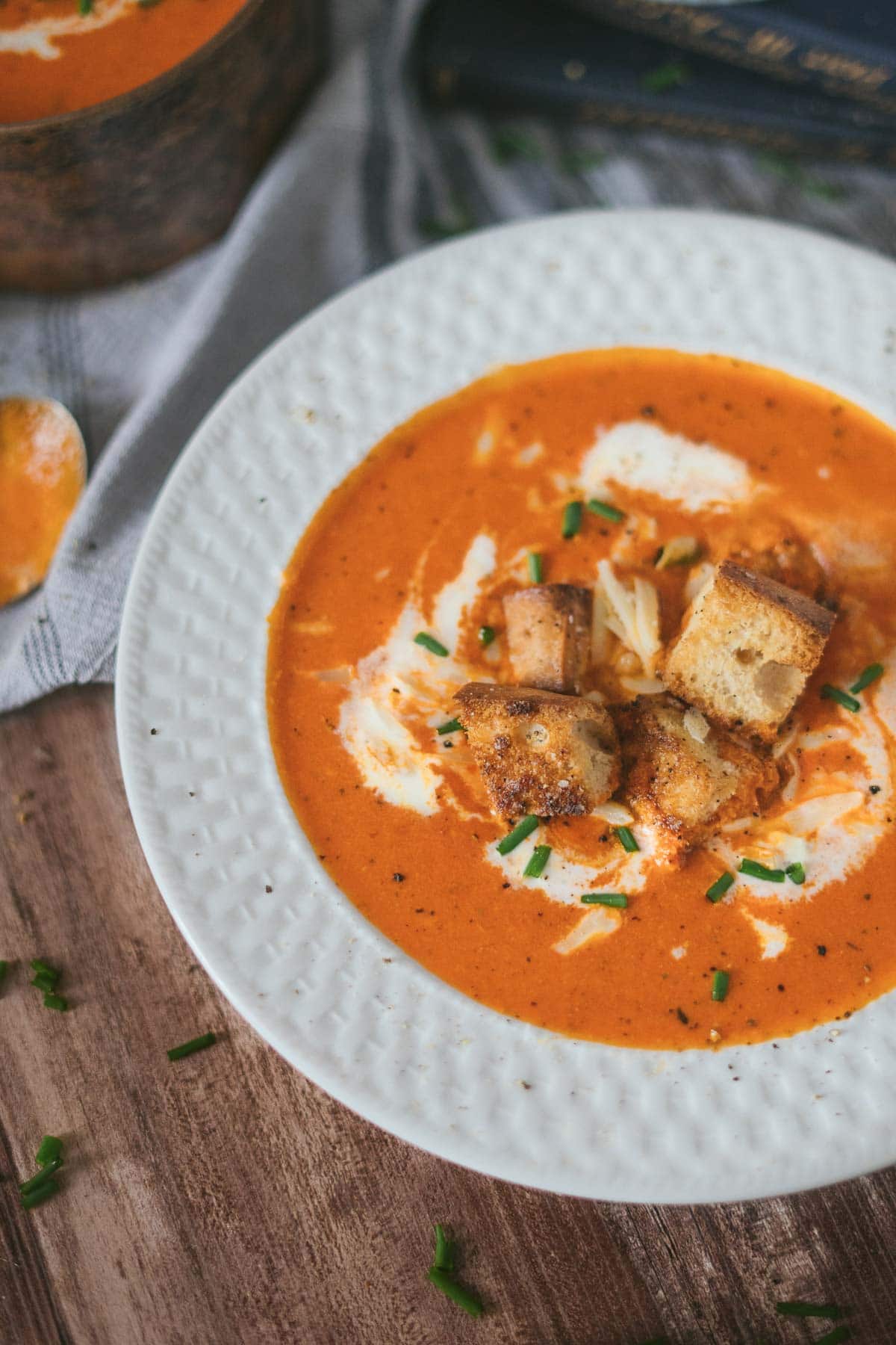 bowl of roasted red pepper soup with croutons.