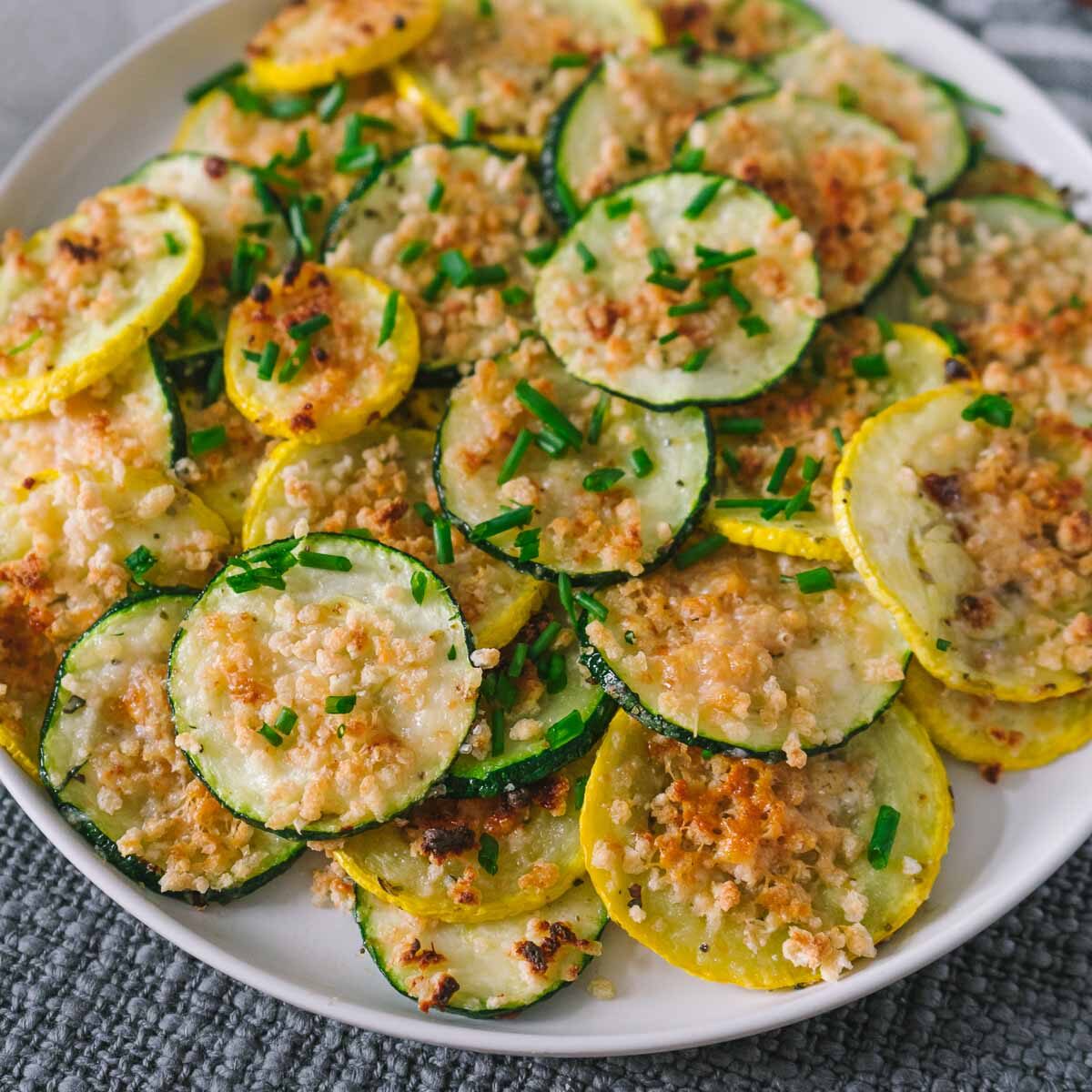parmsean roasted zuchhini and yellow squash on a plate.