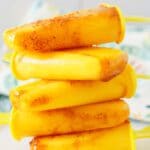 mangonada popsicles stacked on top of each other.