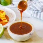 chamoy sauce being spooned into small bowl.