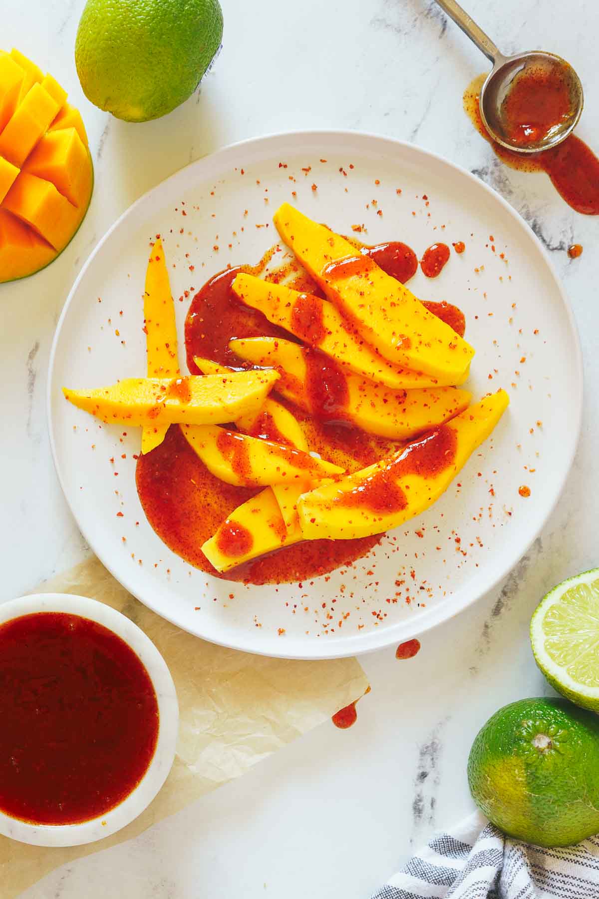mangoes with chamoy sauce on a plate. 