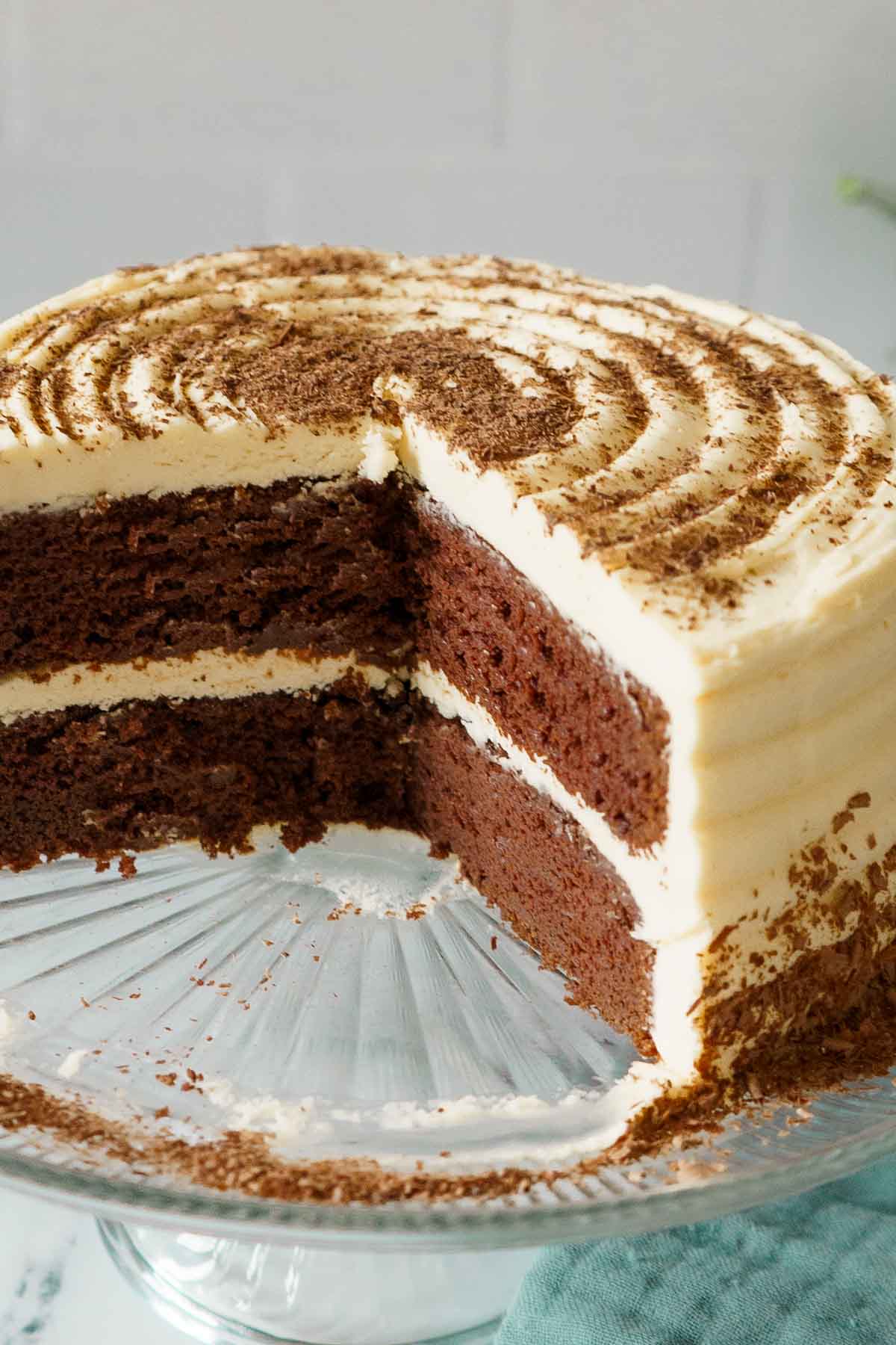 chocolate cake with white buttercream on cake plate.