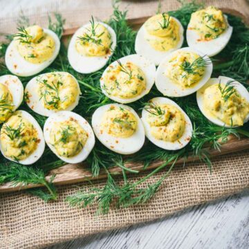 deviled eggs served on a bed of fresh dill.