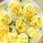 deviled eggs mimosa on a white plate.