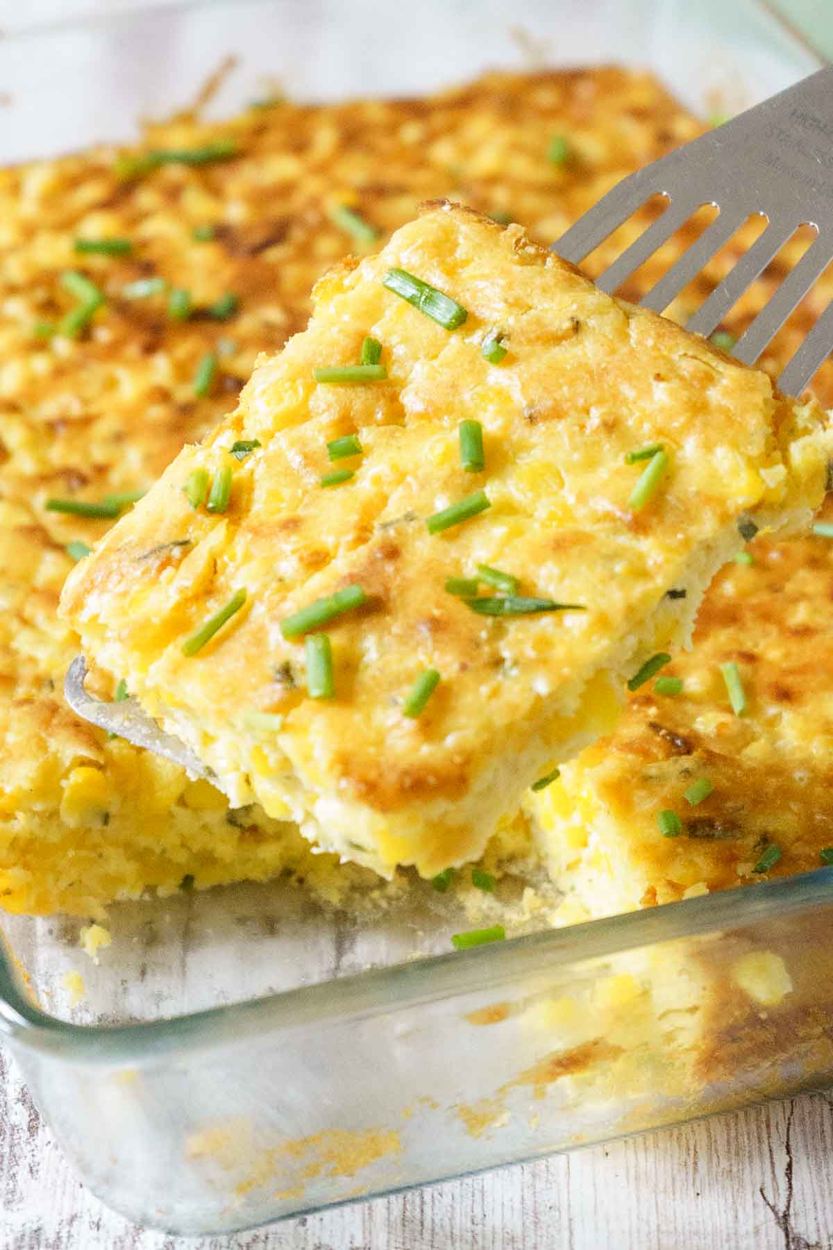 slice of gluten free corn casserole being lifted from serving dish.