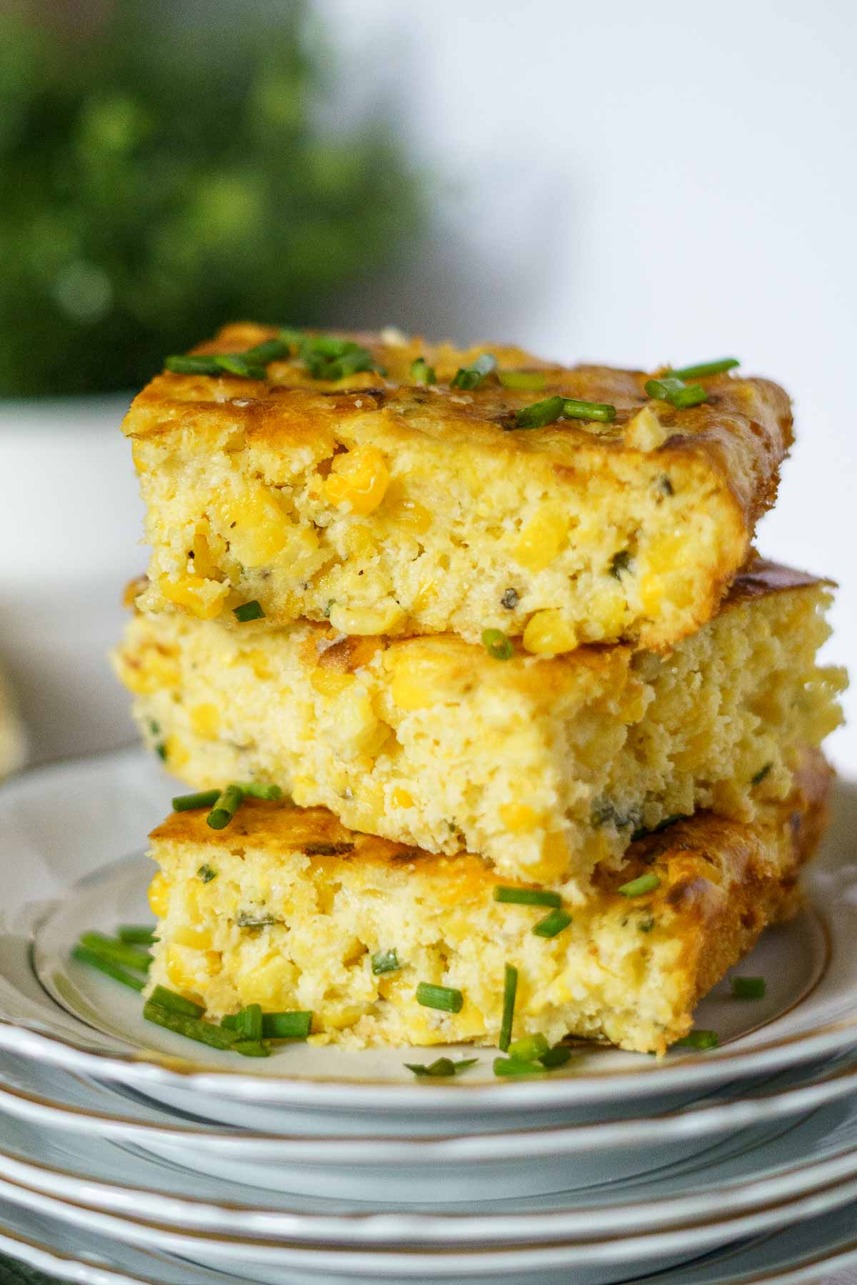 slices of corn casserole stacked on top of each other. 