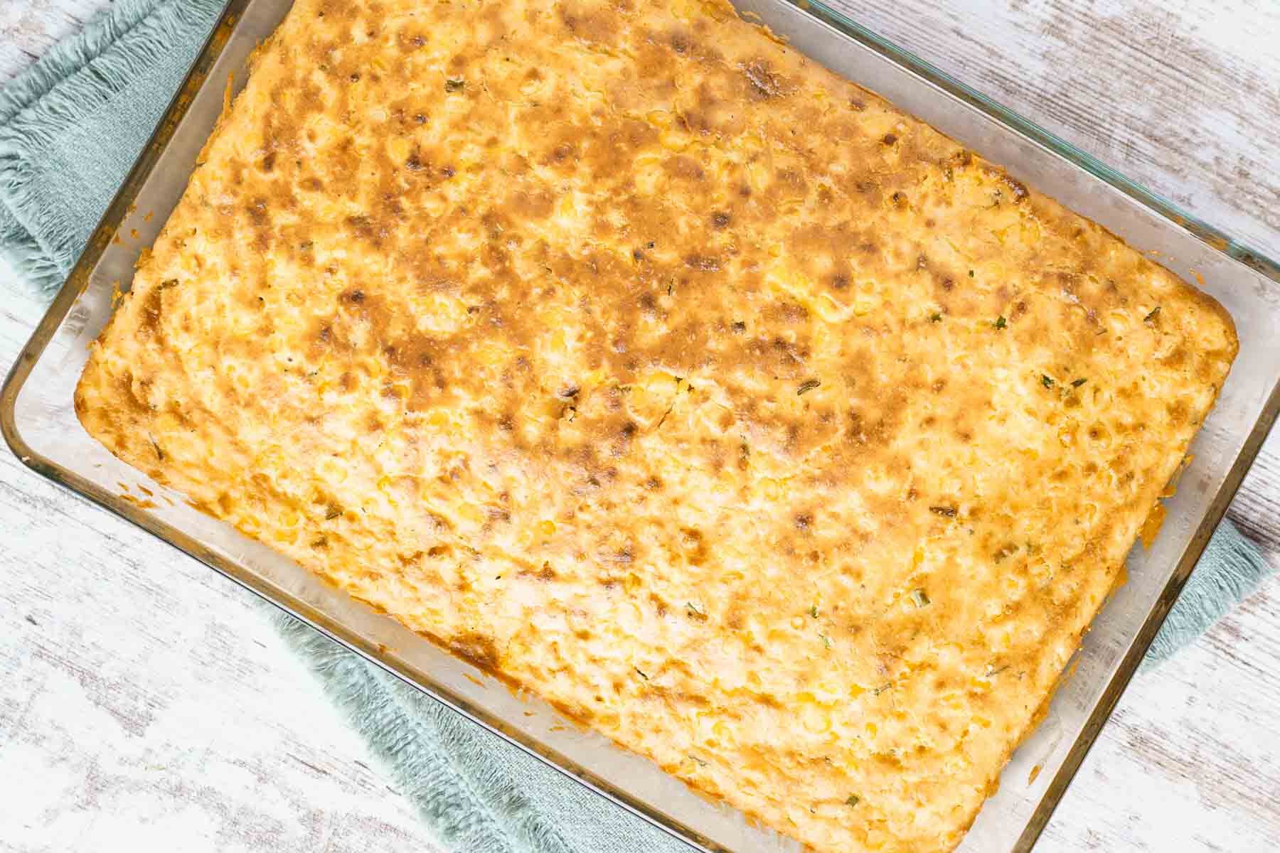 baked corn casserole cooling in a pan. 