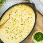 homemade creamed corn in a serving dish with chives.