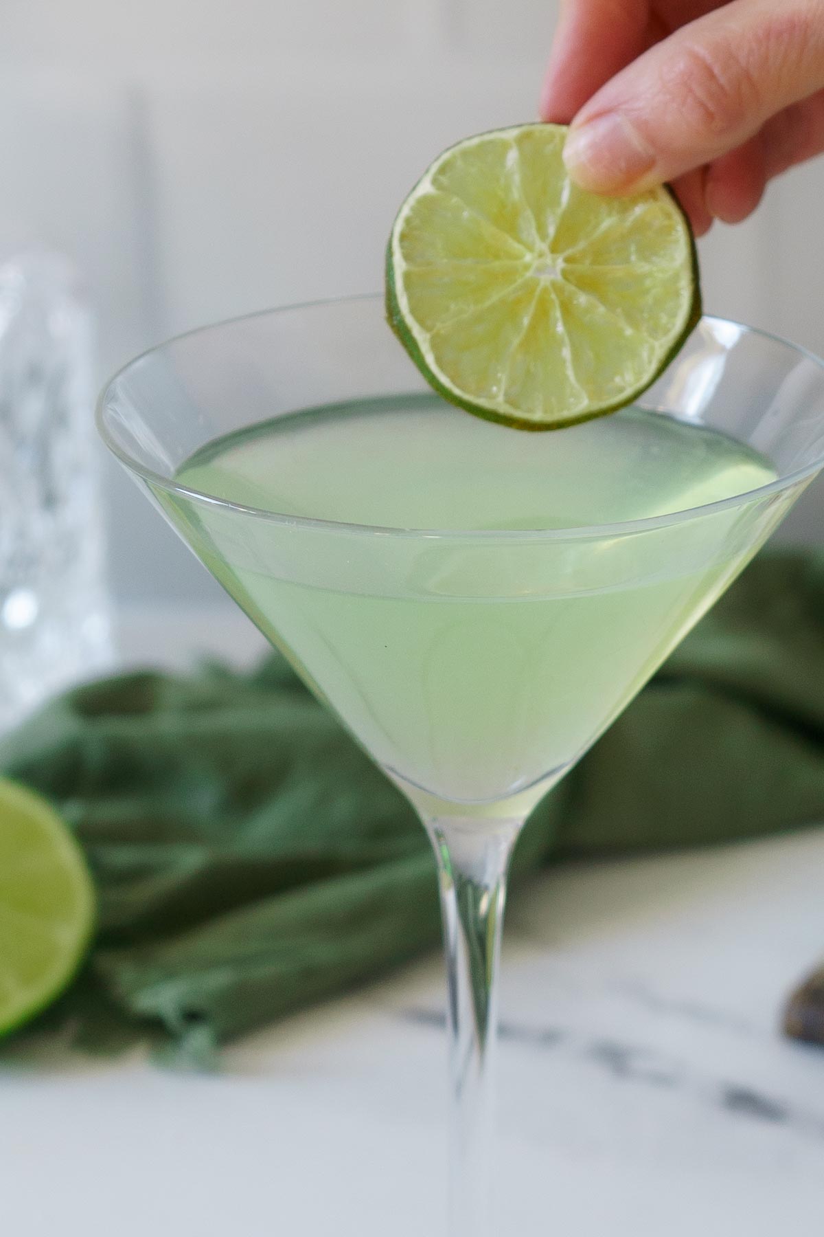 Garnishing a green ghost with a dehydrated lime. 