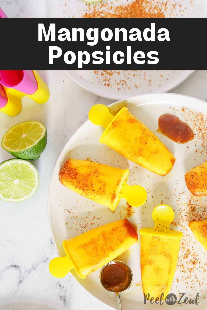 mango popsicles on a plate.
