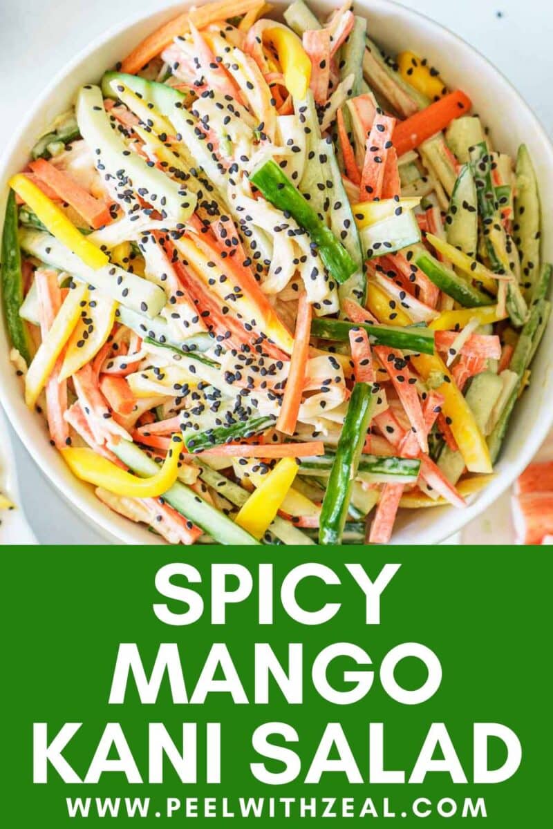 Bowl of spicy kani salad with julienned vegetables, mango, kani, and black sesame seeds