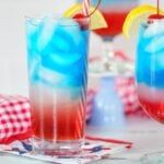 layered red white and blue drink in a tall glass